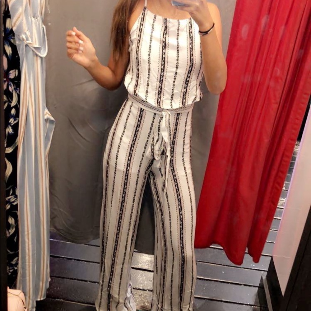 White Jumpsuit with brown and black stripes/accents. Open Back with Tie